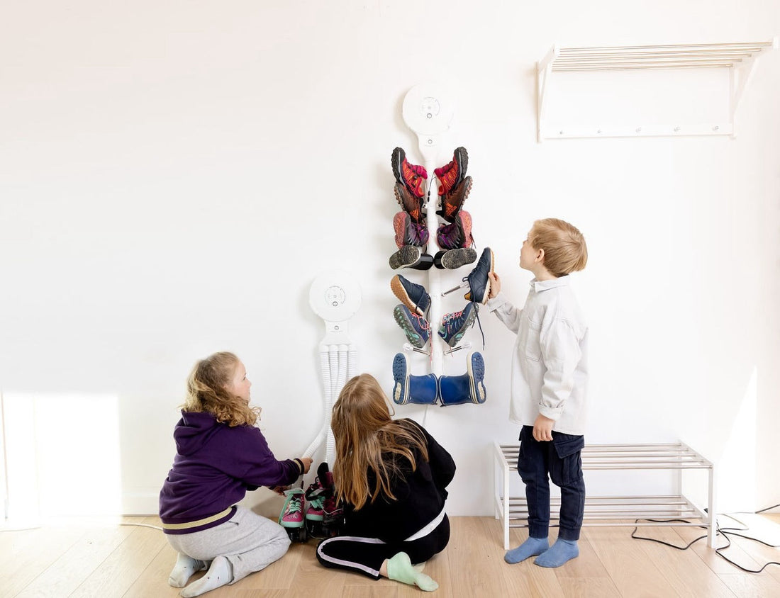 Children hanging shoes on Hedgehog Dryer products, now available at Outdoor School Shop